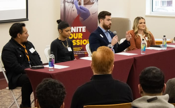 Business reception panelists seated in library chatting