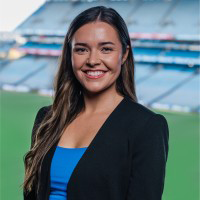 Mary Kate Henry smiling with Croke Park stadium green and seats in background