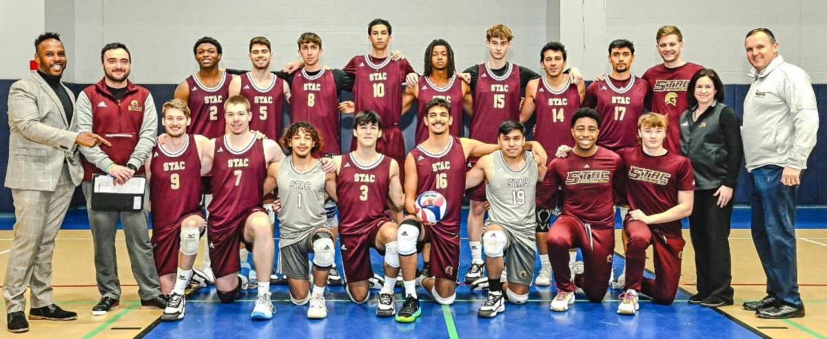 Mens Volleyball team photo with president daly athletic director nicole ryan and vp of student development kevin nesbitt
