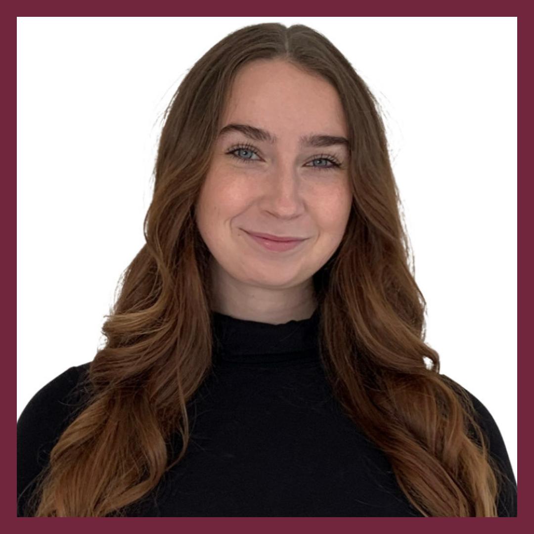 Meghan smiling wearing black turtle neck with white background