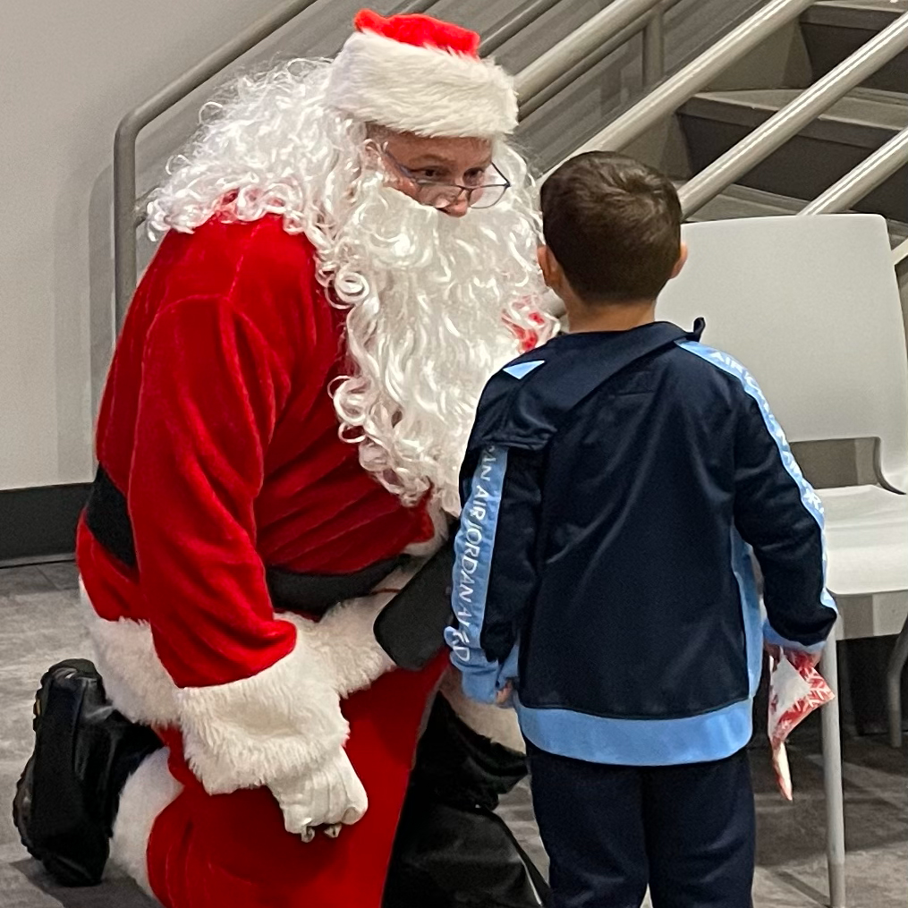 Santa and young student interacting