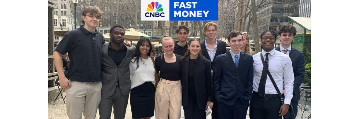 students outside of cnbc smiling for group photo