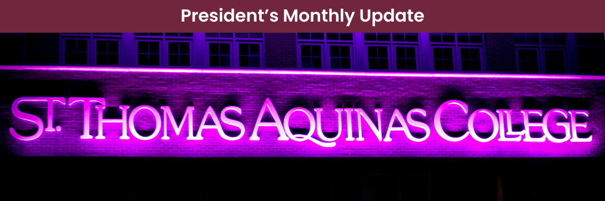 Saint Thomas Aquinas College Sign lit in purple