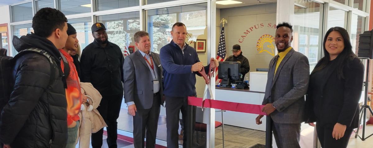 campus safety ribbon cutting with students and staff gathered around new space in aquinas hall