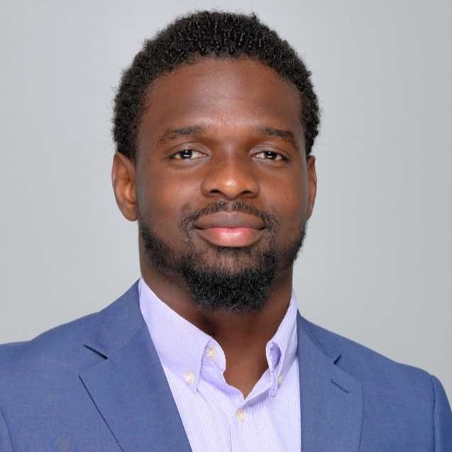 Tchasky smiling wearing blue suit