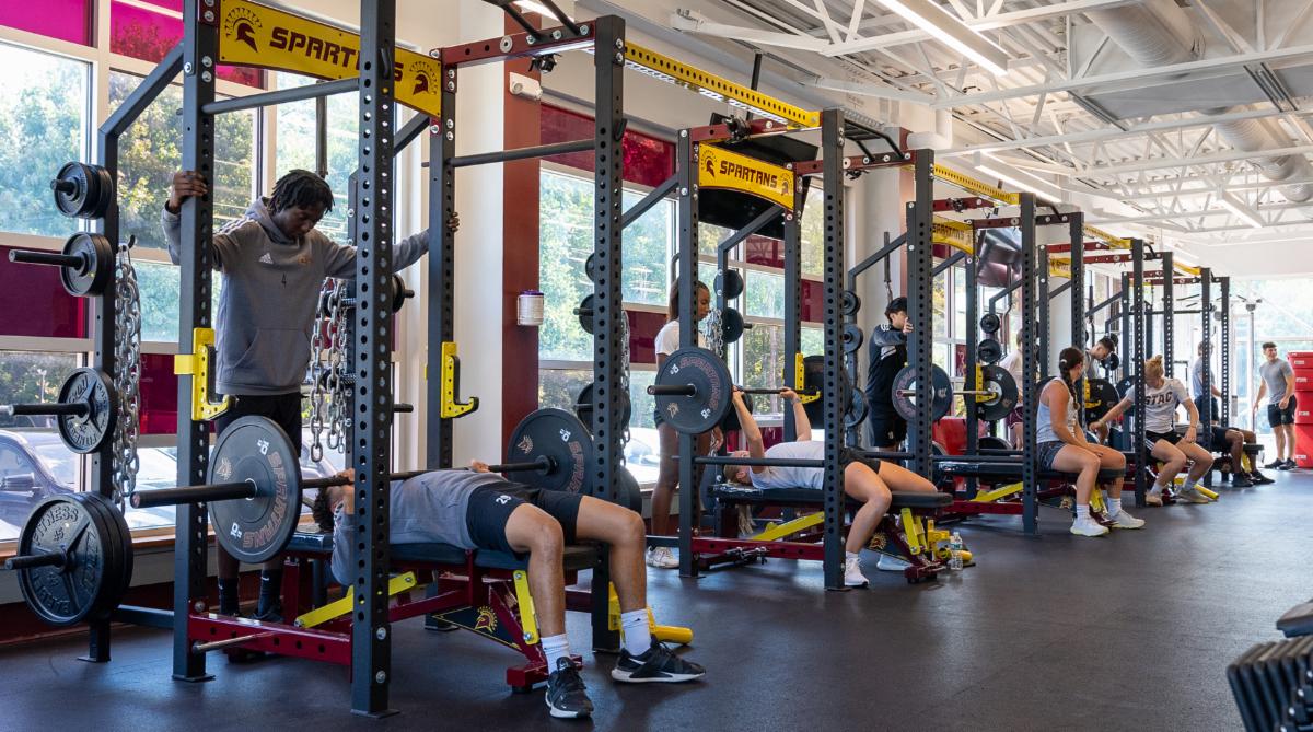 Kraus Fitness Center machines with students using weights