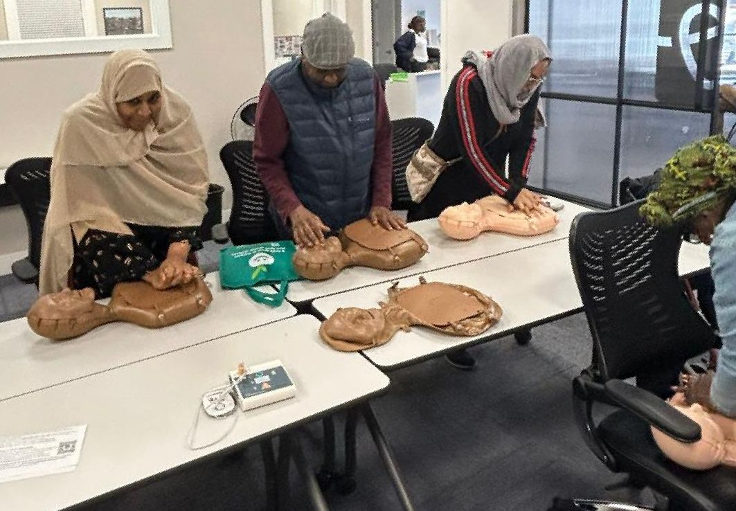 Photo of CPR training class attendees practicing CPR on manikins. 