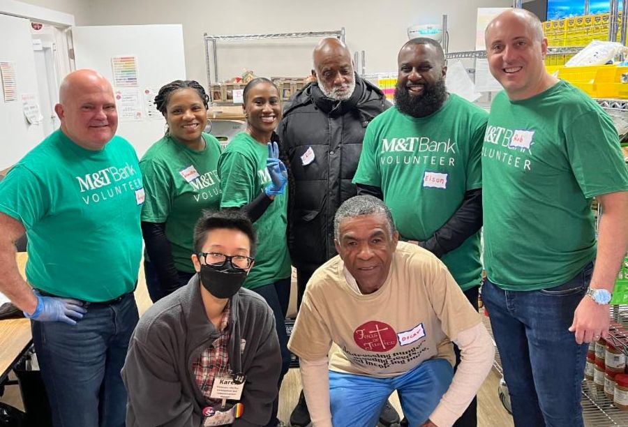 Photo of volunteers from M&T Bank and others pose for the start of a volunteer shift.