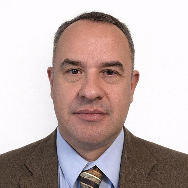 Man in suit half smiling portrait