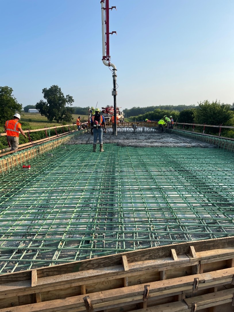 Contractor crews pour the new Chariton County Route F Palmer Creek bridge deck.
