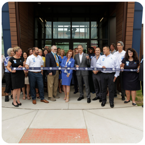 Dutch Point ribbon cutting. Group of people at new branch.