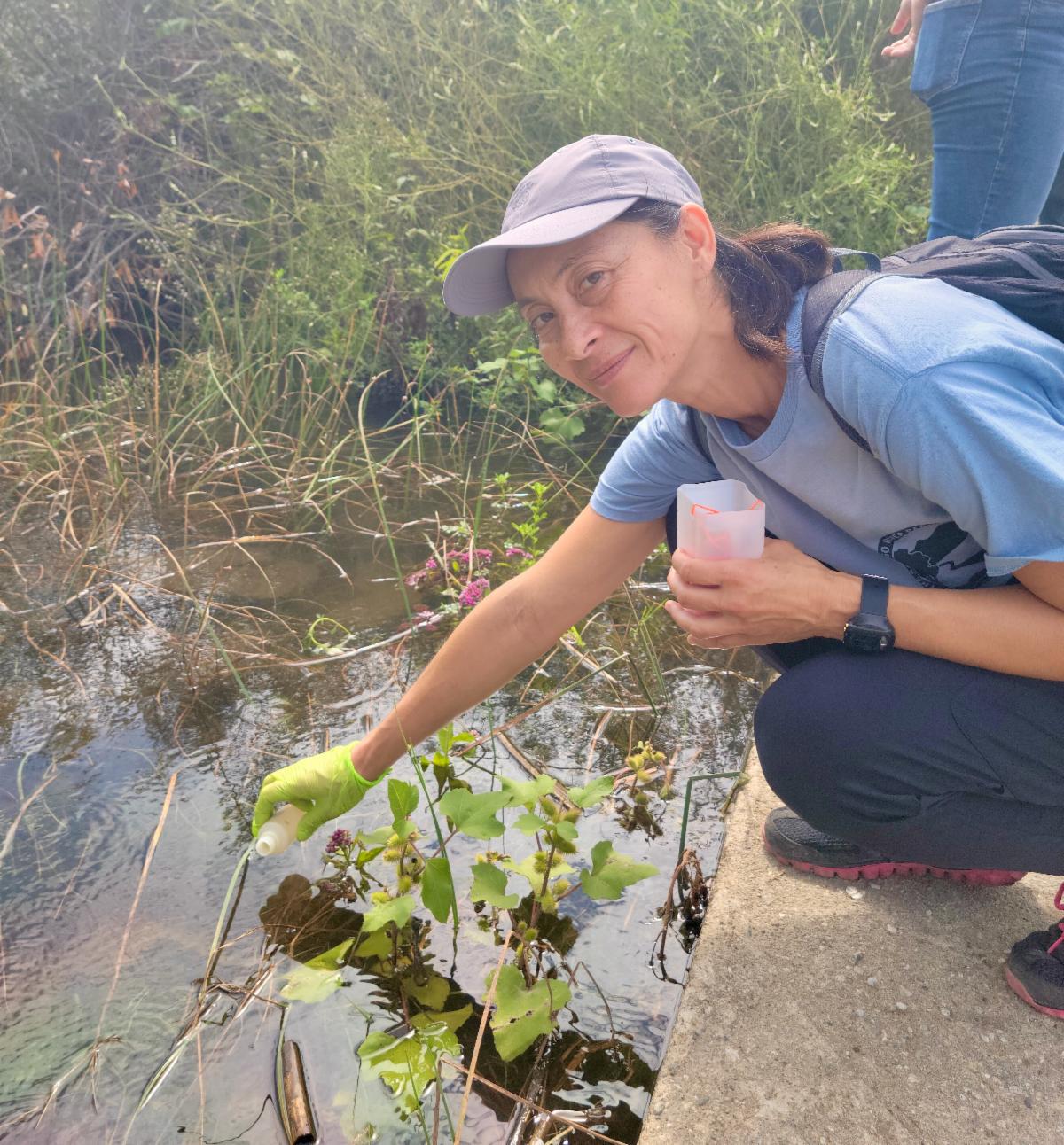 Volunteer Marina Pak testing water quality of the San Diego River