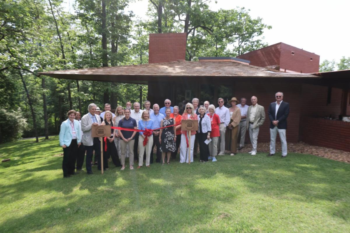 Group posed for ribbon cutting of roof at Kraus House