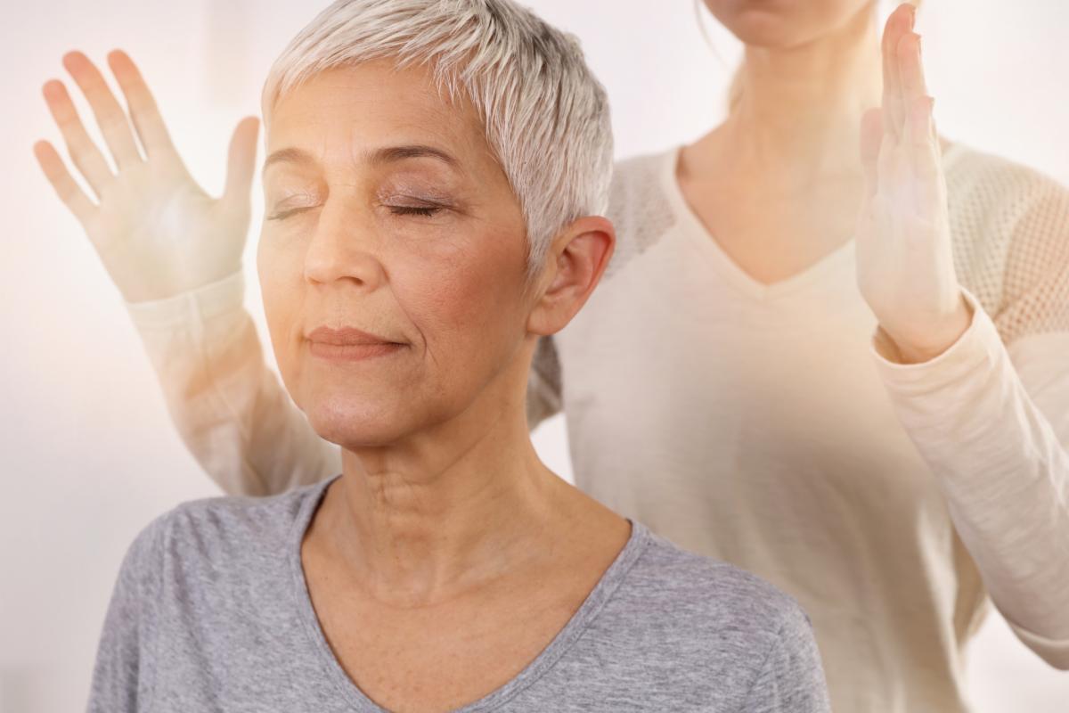 Woman having reiki healing treatment  alternative medicine concept holistic care