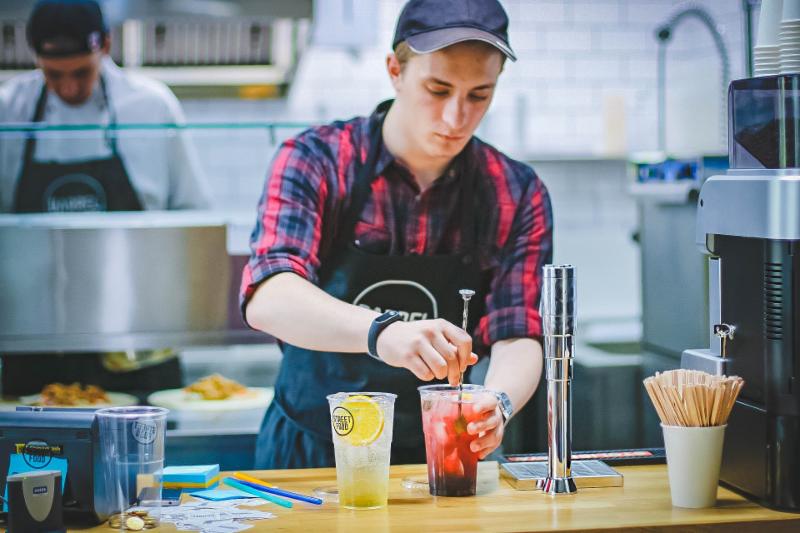 young man working at a cafe