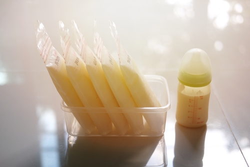 Frozen breastmilk in storage bags and baby bottle_ vintage style