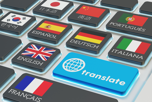 Foreign languages translation concept_ online translator_ macro view of computer keyboard with national flags of world countries on keys and blue translate button