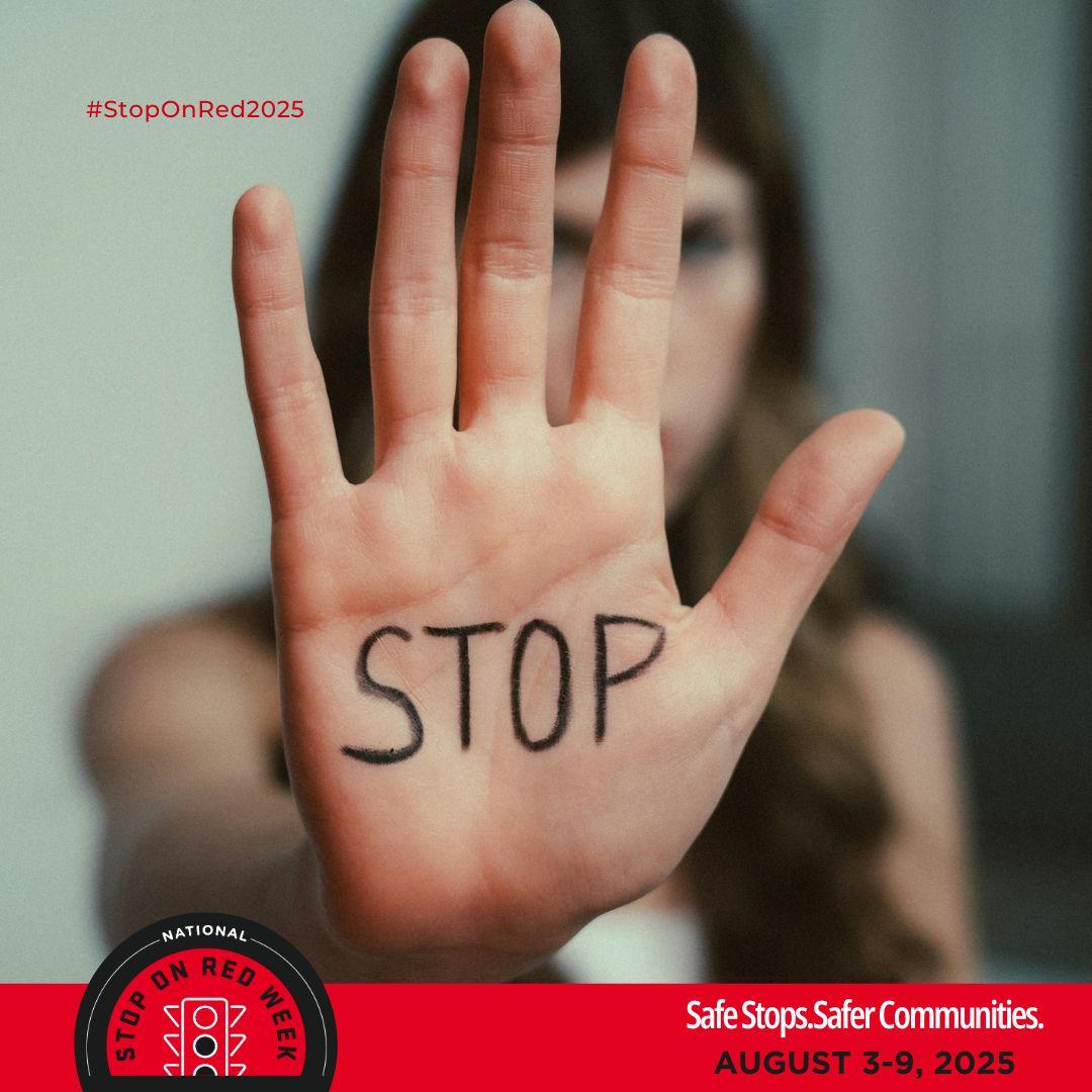 A girl holding her hand up to stop something the word stop is written on her hand Stop on Red Week 2025 Safe Stops Safer Communities August 3 to 9