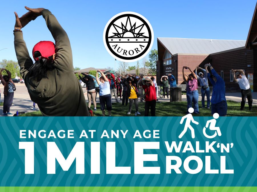 A group of older adults stretching before their walk. 1-mile walk 'n' roll
