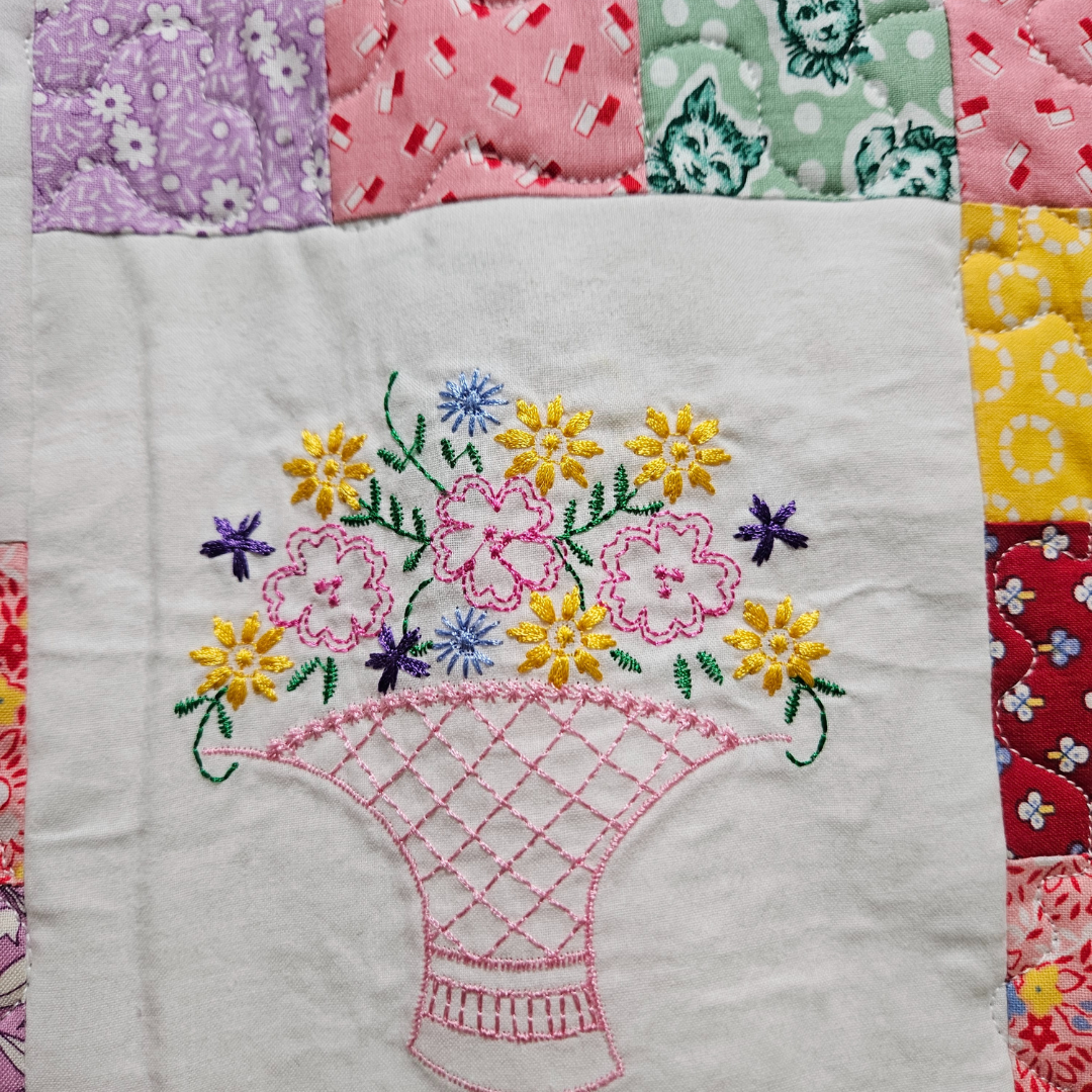 a floral embroidered patch that's part of an elaborate quilt