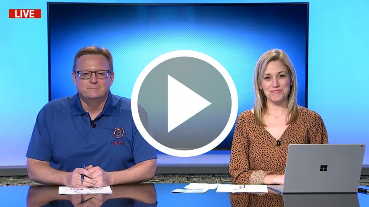 Dr. Ryder Warren and Emily Conklin sitting at the NHSTV news desk