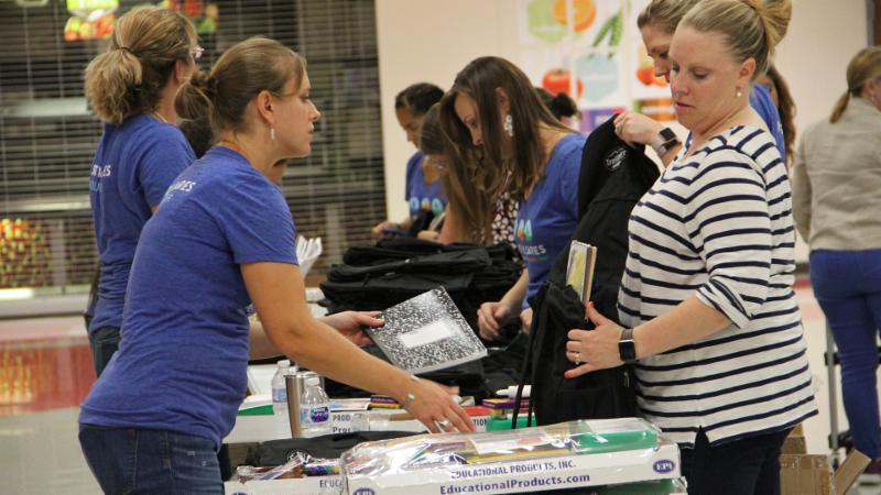 Galderma employees stuff backpacks