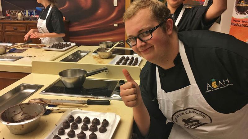 A Byron Nelson culinary arts student poses at a chocolate lesson in Italy