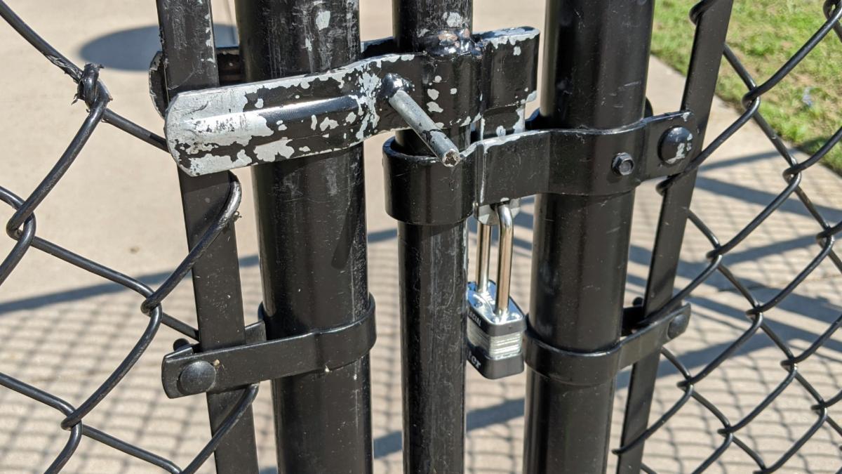 A locked gate to an athletic complex.