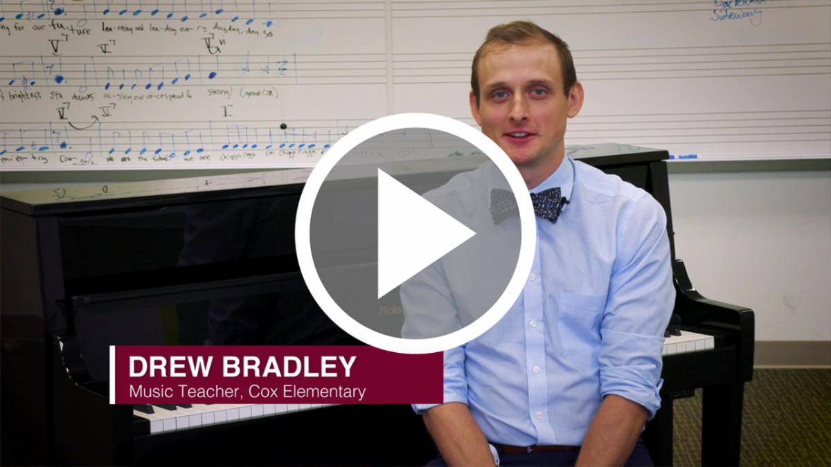 A still image from a video featuring Drew Bradley by a piano