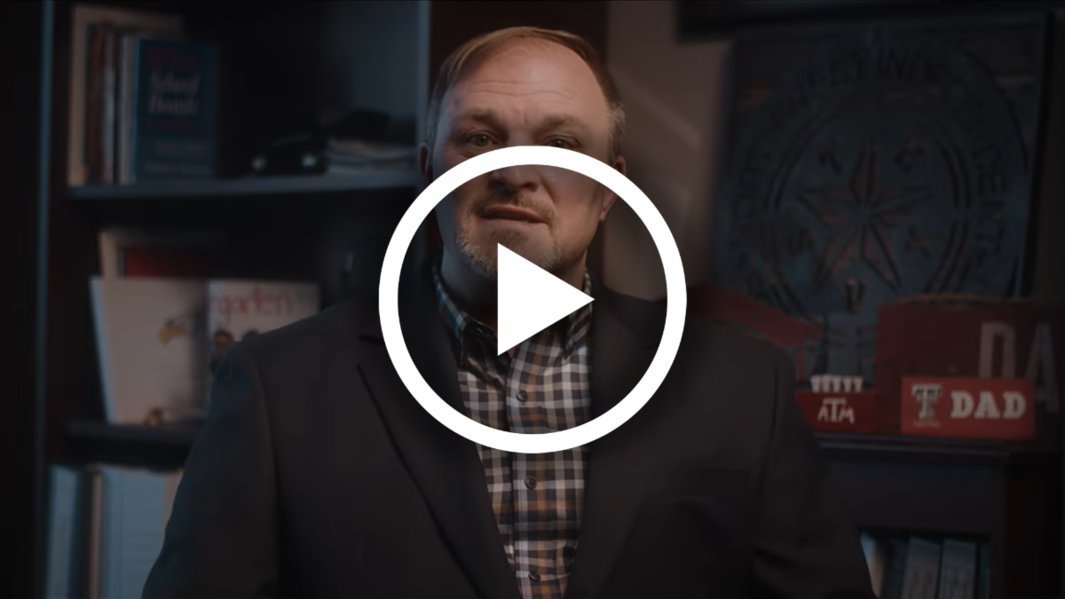 A still frame of Dr. Foust speaking in his office with a play button overlayed