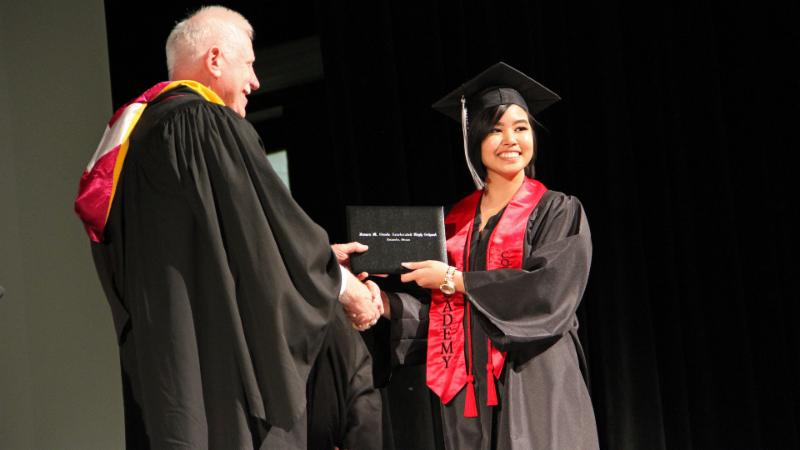 A student graduates from Steele in 2017
