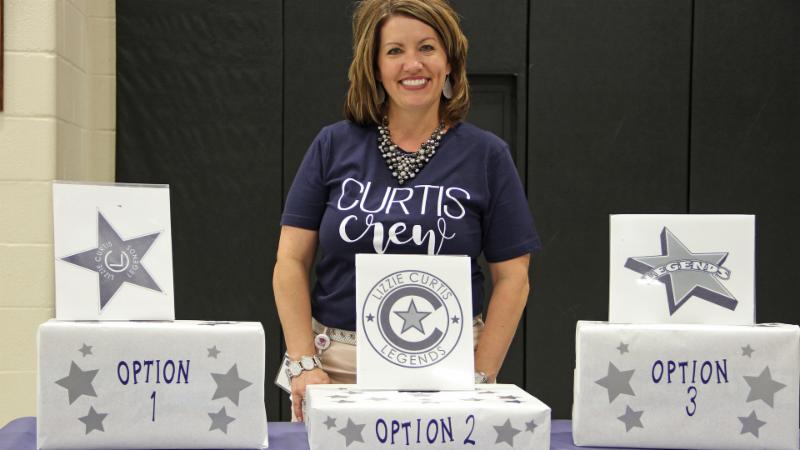Principal Carrie Pierce poses with Curtis Elementary logo options