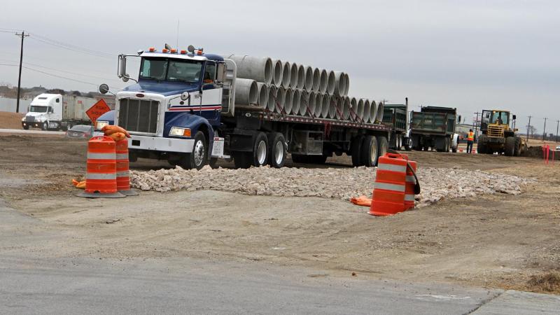 Trucks move materials at the U.S. Rotue 287 ramp project