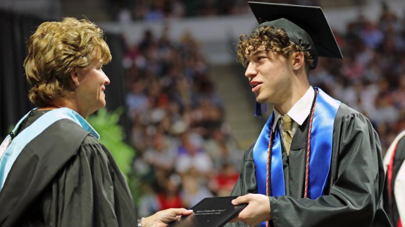 A Byron Nelson student accepts his diploma