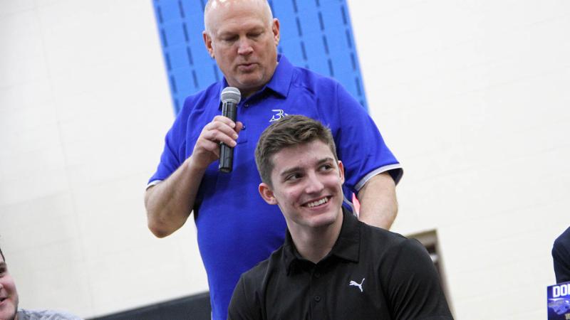 A Byron Nelson student-athlete and coach celebrate signing day