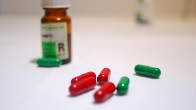 A bottle of medicine and pills