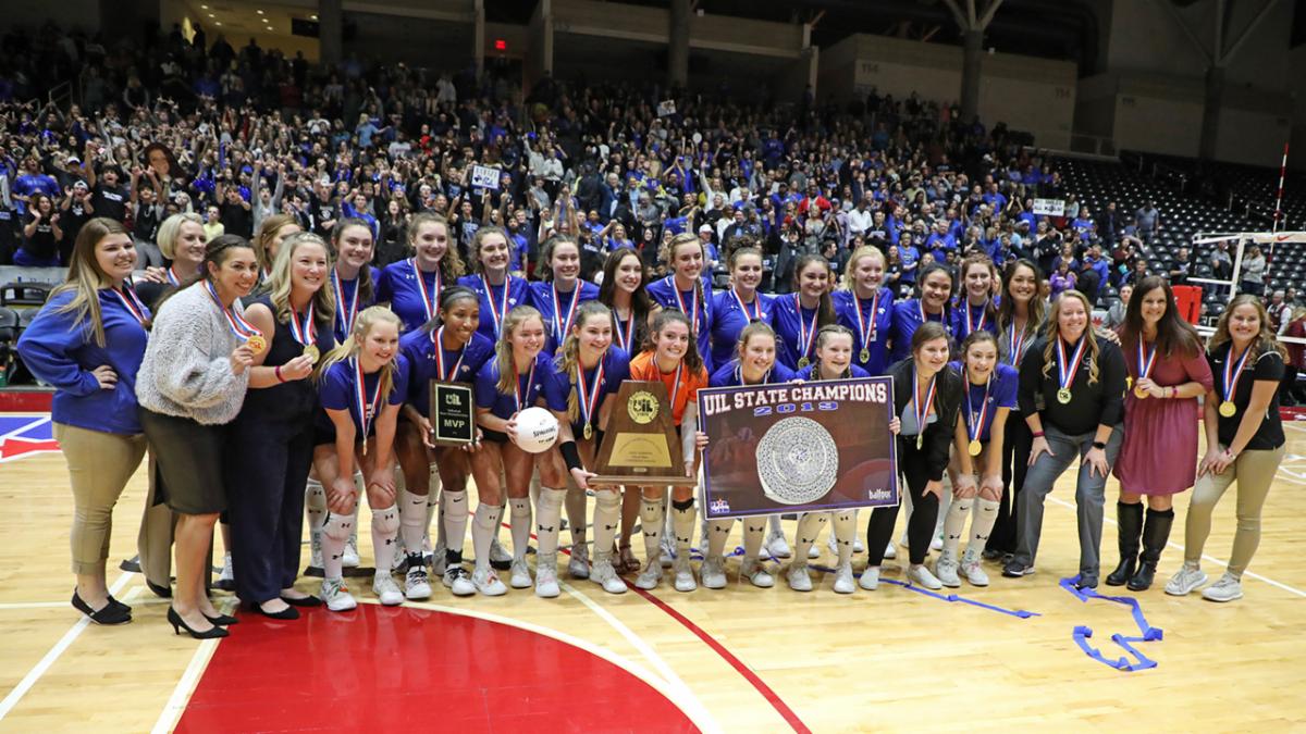 The Byron Nelson volleyball team poses with their trophy and medals after winning the 2019 state championship.