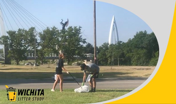 A girl and boy pick up trash in a park in downtown Wichita, with the Keeper of the Plains in background. "Wichita Liter Study"