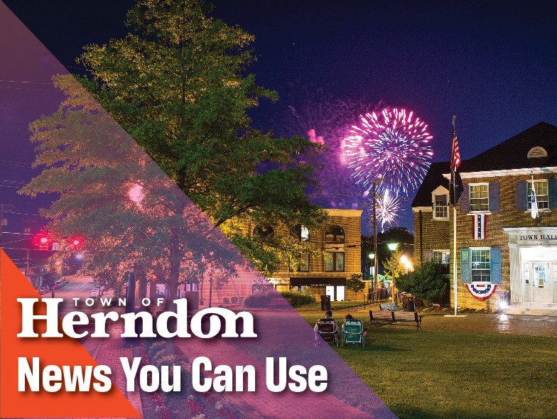 Fireworks explode in the sky  between Town Hall and Depot