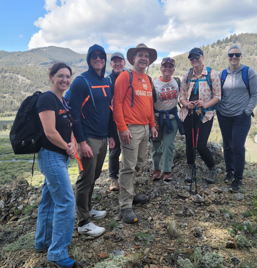 President Wagner and a group pose for a photo at Field Camp