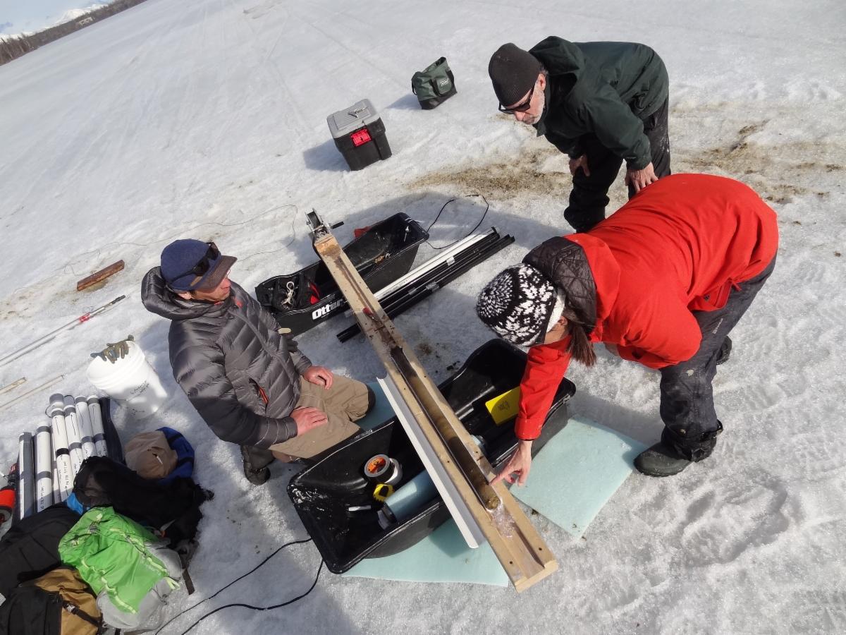 Brad Baxter Lesleigh Anderson and Bruce Finney examine a sediment core at April Fools Lake. Photo credit Carson Baughman and Lesleigh Anderson courtesy of the U.S. Geological Survey