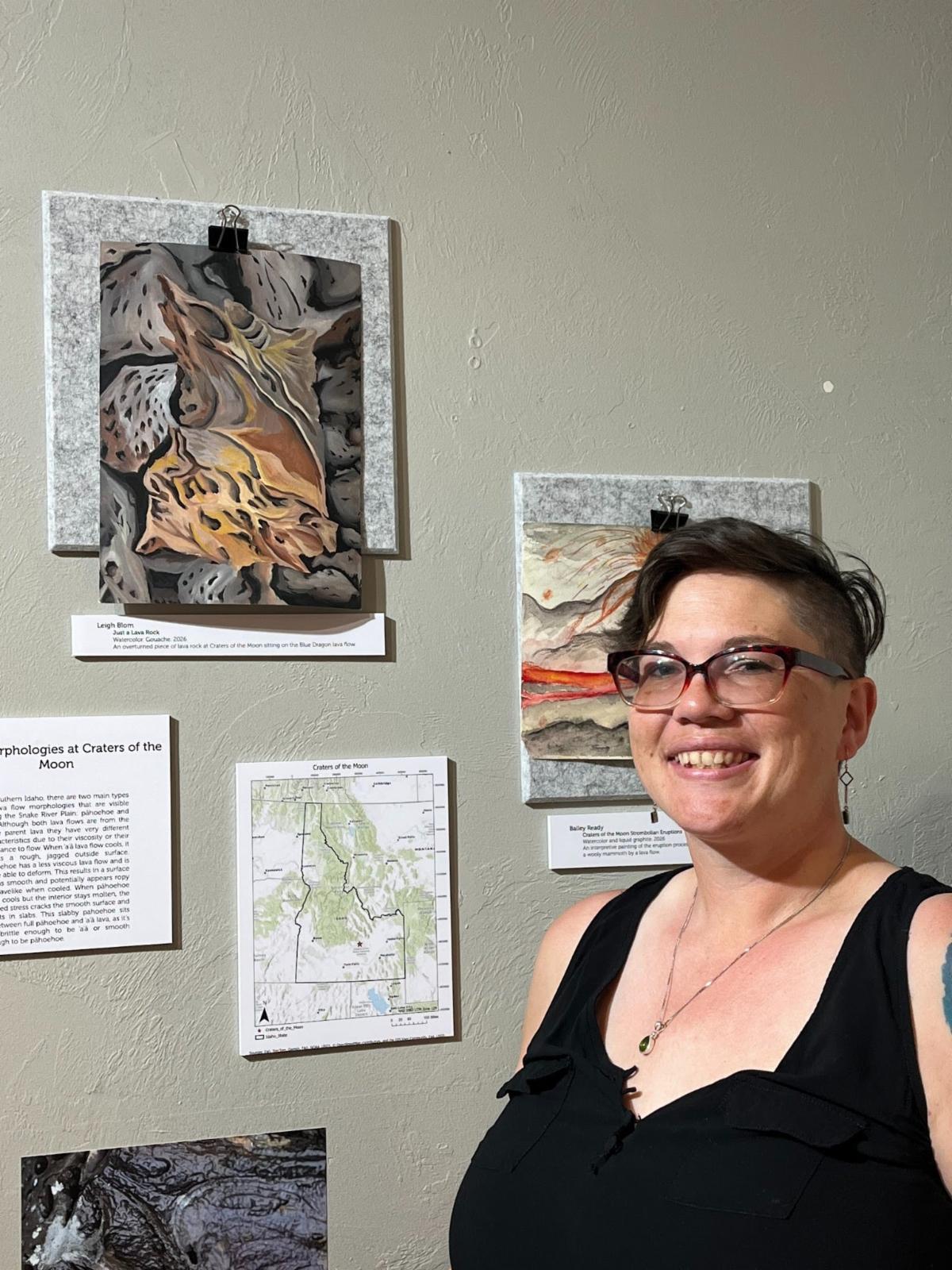 Leigh Blom poses with a photo of her artwork