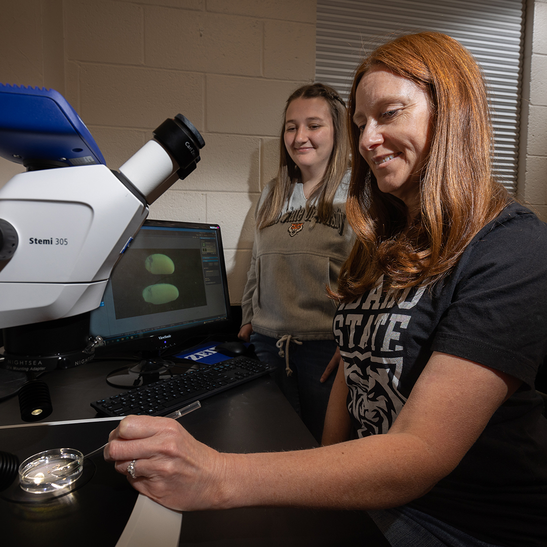 Heather Ray assistant professor foreground and Mikayla Macaluso pose for photos
