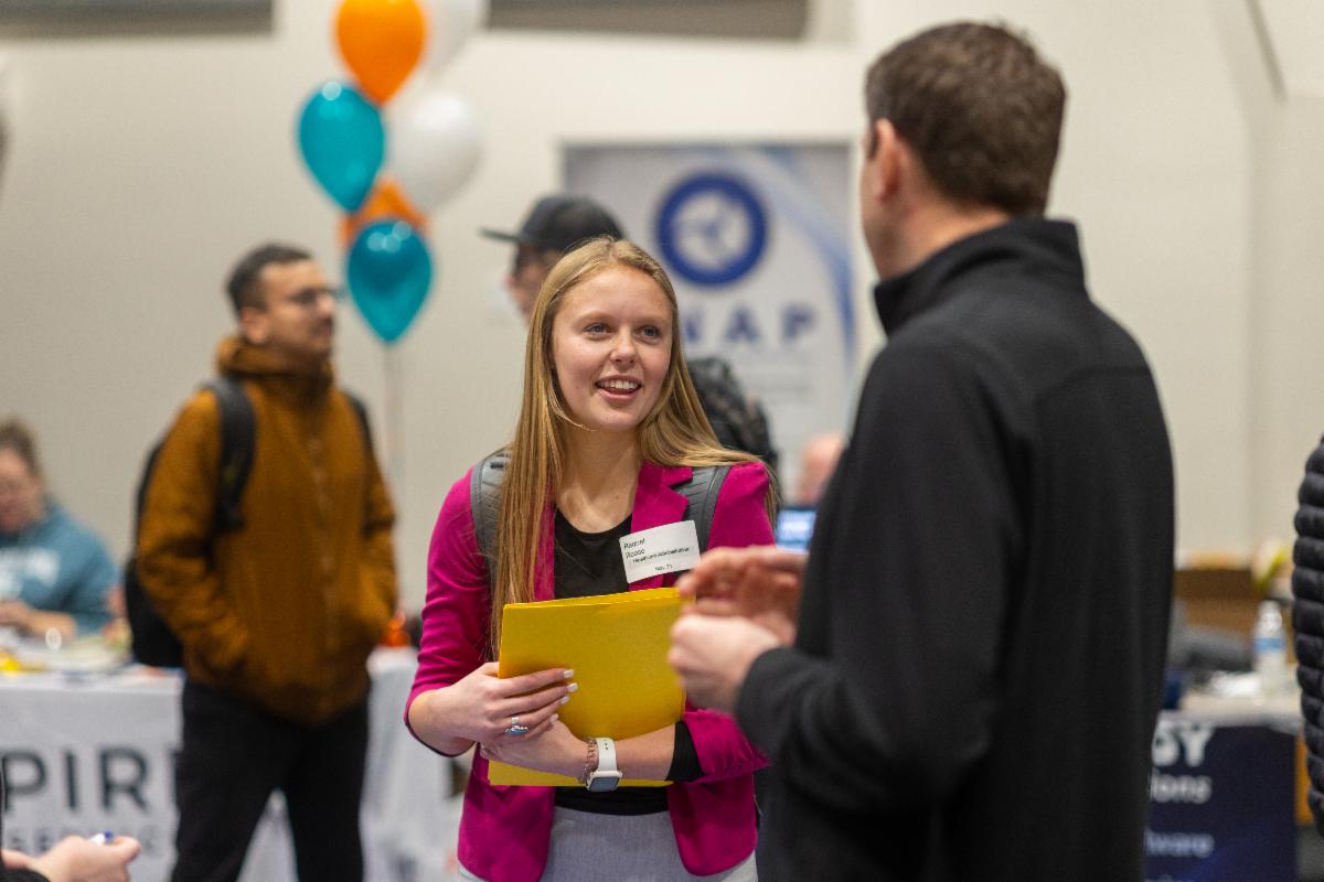 A student speaks with a company rep at an ISU Career Fair