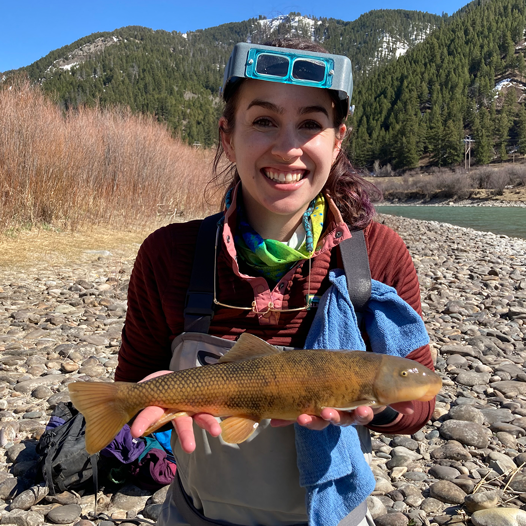 Brandy Smith poses for a photo holding a green sucker near the Snake River