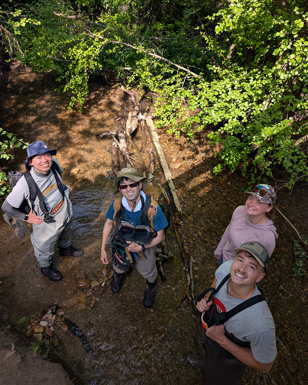 Kenta Iwasaki Shodai Sho Iwagami Anna Sniadach and Kent Merrill pose for a photo in a creek.