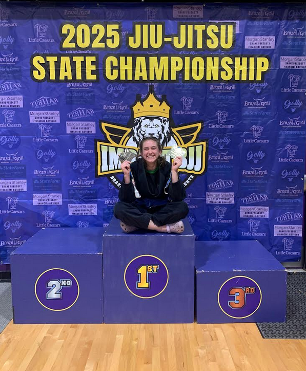 Eliana CraigSmith poses for a photo holding her awards at the Idaho State BJJ Championship