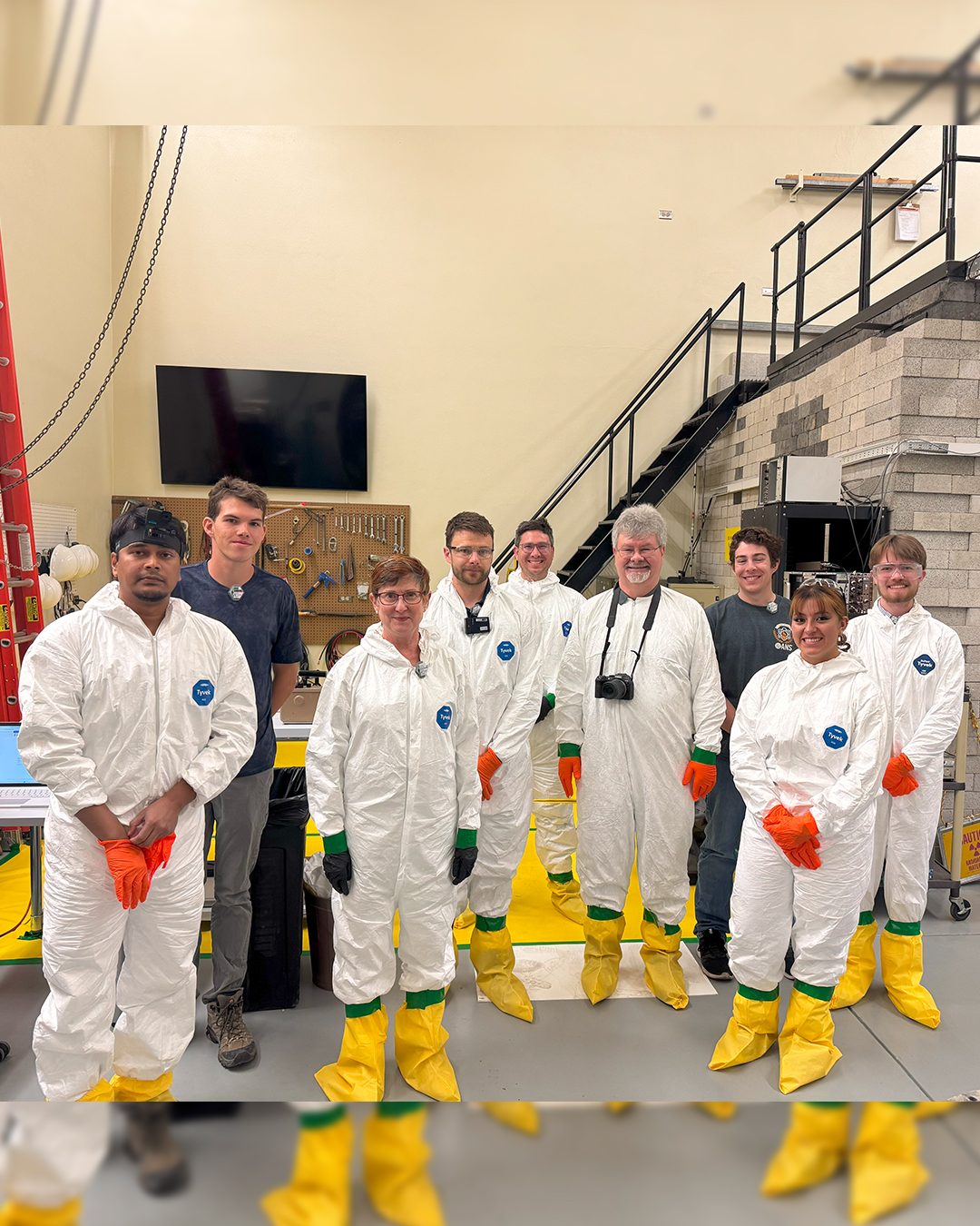 Students faculty and staff pose for a photo in ISU's Nuclear Engineering Laboratory