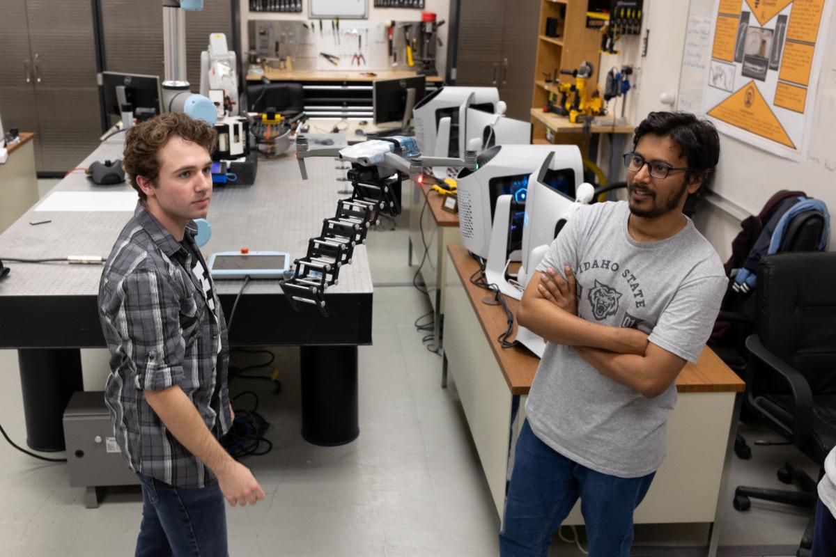 Two mechanical engineering students at Idaho State University demonstrate their project