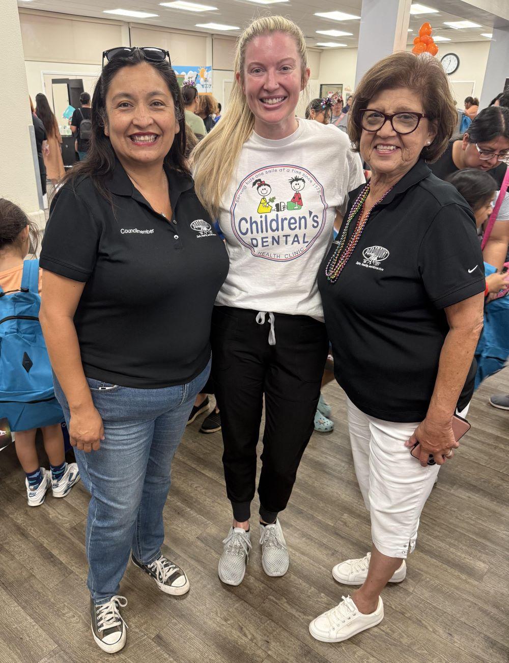 Dr. Mackenzie with two city council members at the City of Paramount Back to School Giveaway Event